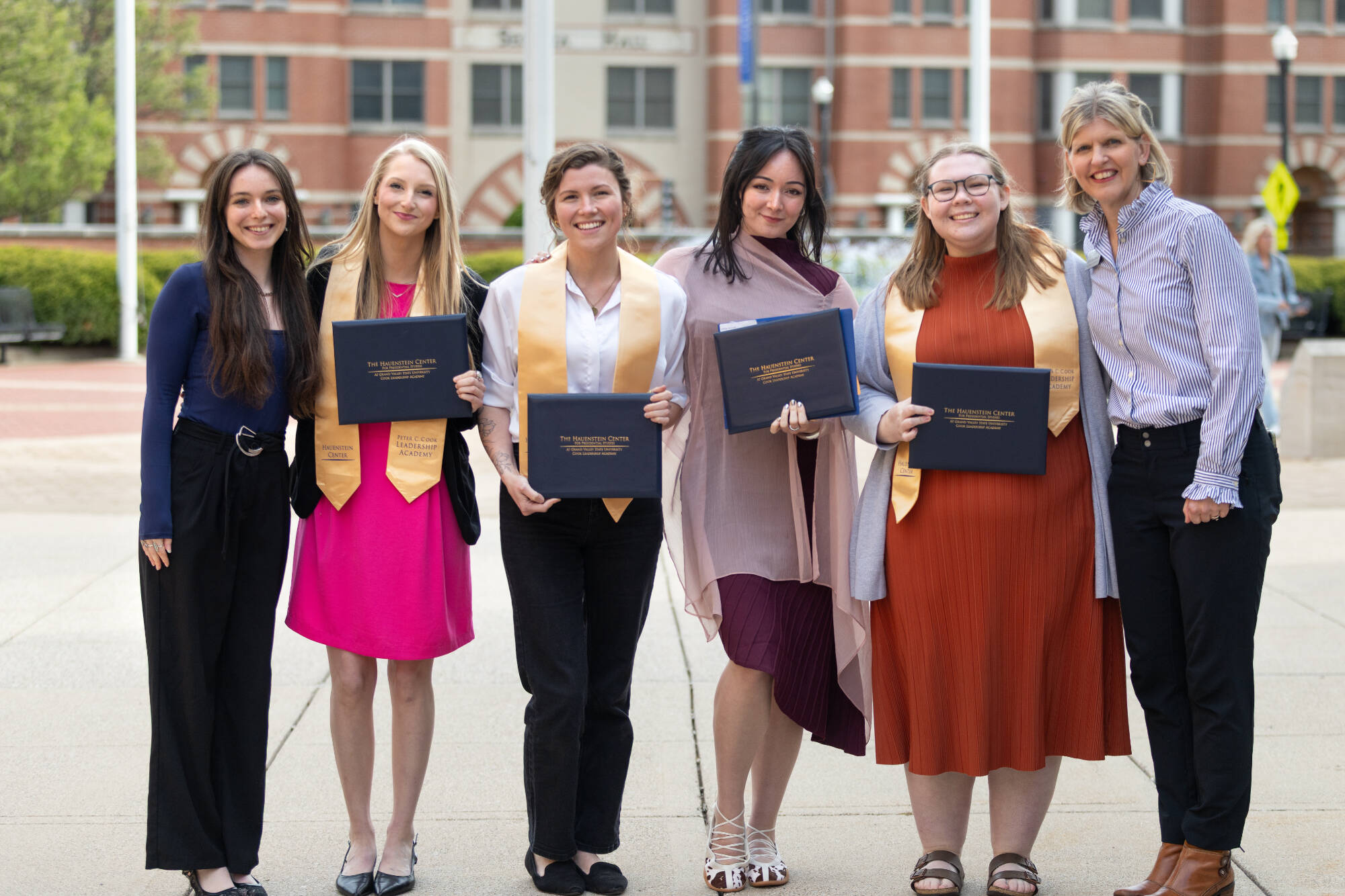 Students and staff pose with certificates